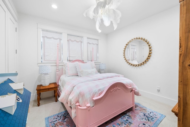 bedroom with carpet floors and a chandelier