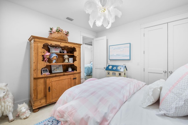 bedroom featuring a closet and light carpet