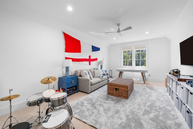 living room featuring ceiling fan, light carpet, and vaulted ceiling