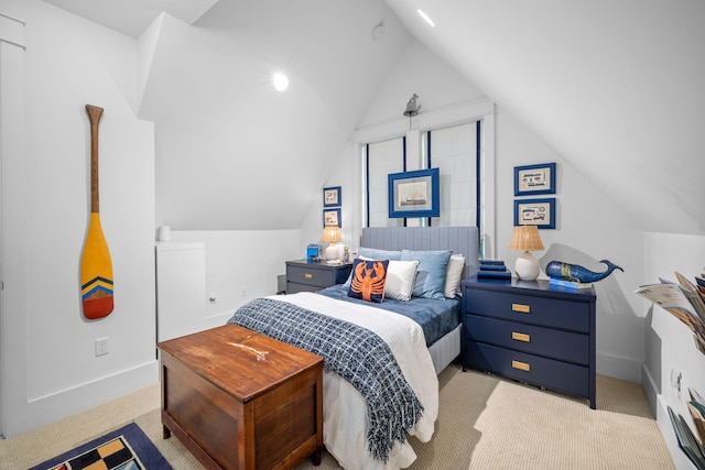 carpeted bedroom with lofted ceiling