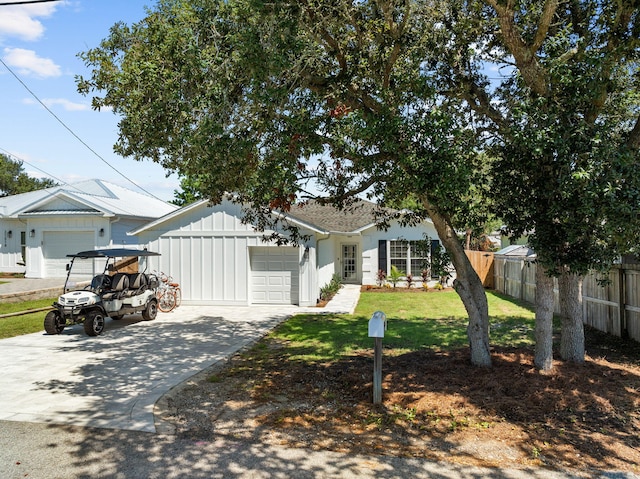 view of front facade with a garage and a front lawn