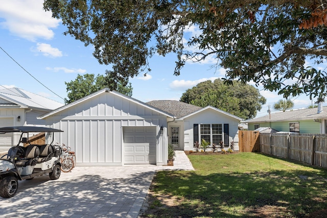 view of front of home with a garage and a front yard