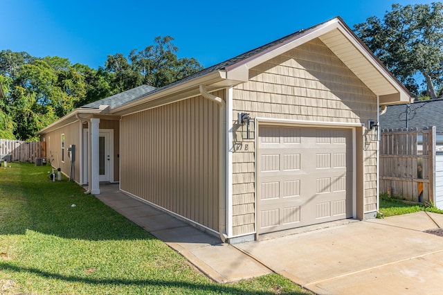 garage with central AC and a lawn