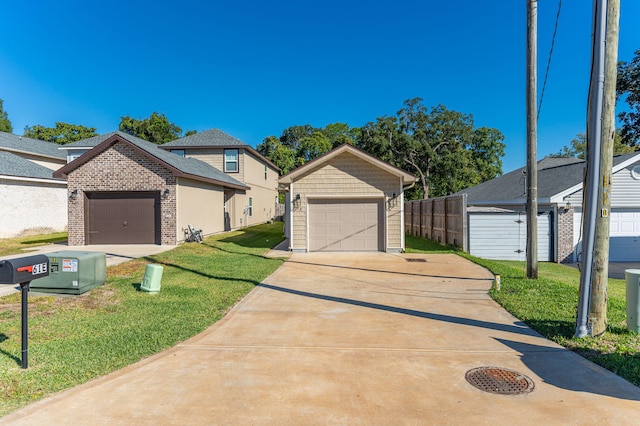 view of front facade with an outdoor structure, a garage, and a front lawn