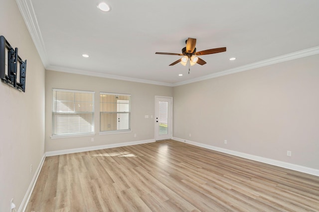 spare room with ornamental molding, light wood-type flooring, a healthy amount of sunlight, and ceiling fan