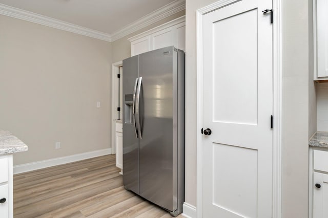 kitchen with white cabinetry, stainless steel refrigerator with ice dispenser, light stone counters, and light wood-type flooring