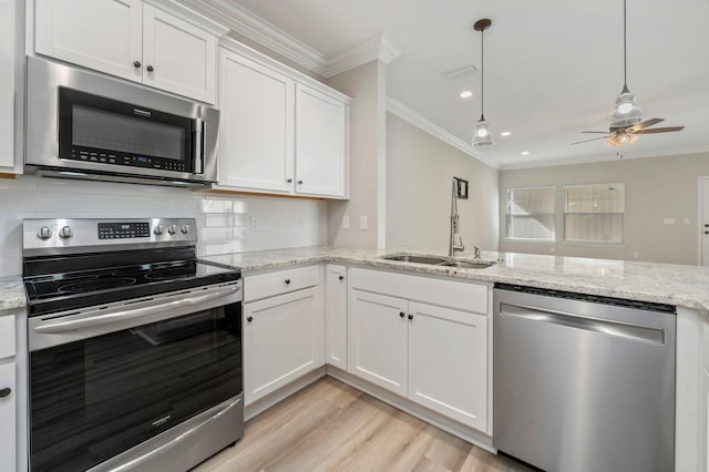 kitchen with light hardwood / wood-style flooring, white cabinets, stainless steel appliances, and light stone counters