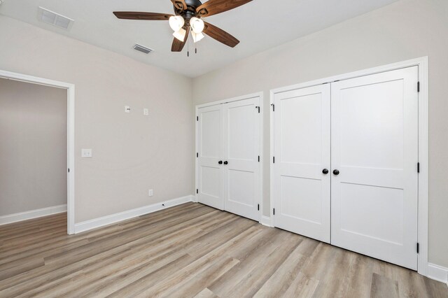 unfurnished bedroom featuring ceiling fan and light wood-type flooring