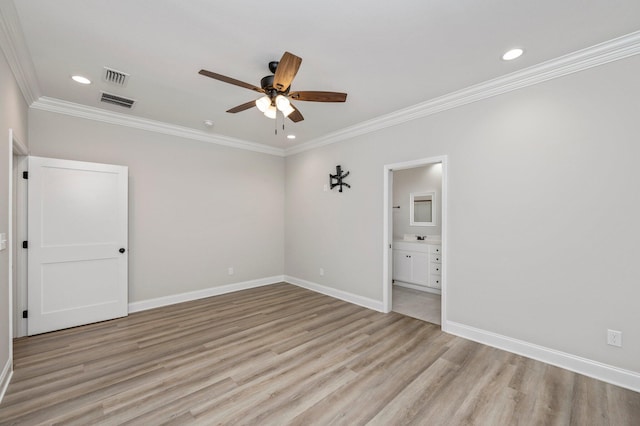 spare room with ceiling fan, ornamental molding, and light wood-type flooring