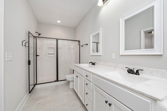 bathroom with toilet, tile patterned flooring, vanity, and a shower with door