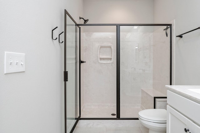 bathroom with vanity, tile patterned flooring, toilet, and walk in shower