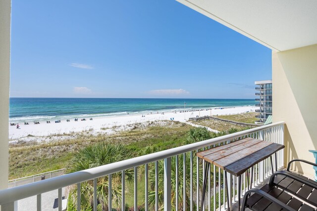 balcony with a beach view and a water view