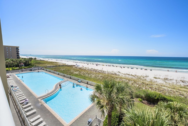 view of pool featuring a beach view and a water view