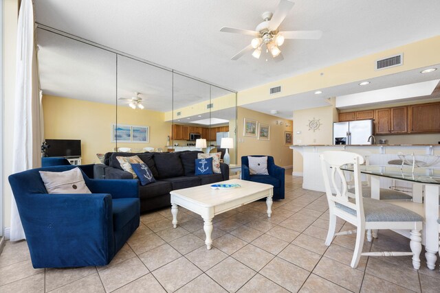 living room featuring ceiling fan and light tile patterned flooring