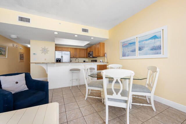 dining room featuring light tile patterned flooring