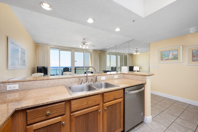 kitchen featuring dishwasher, a textured ceiling, sink, and ceiling fan