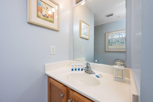 bathroom with a textured ceiling and vanity