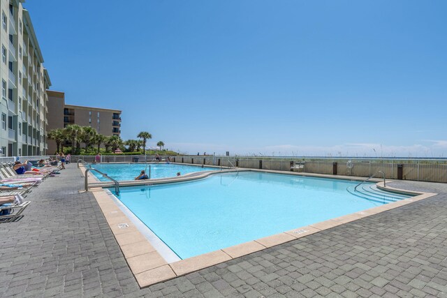 view of swimming pool featuring a patio area