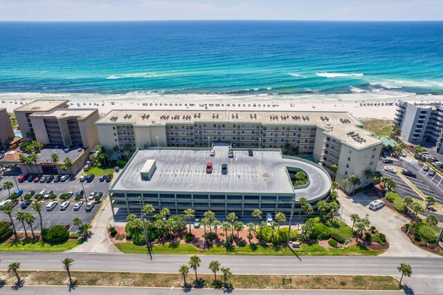 birds eye view of property featuring a water view and a beach view