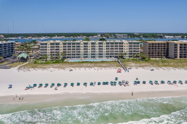 drone / aerial view featuring a water view and a beach view