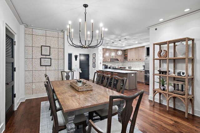 dining room with dark hardwood / wood-style floors and a chandelier