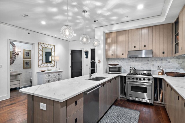 kitchen featuring appliances with stainless steel finishes, dark hardwood / wood-style flooring, kitchen peninsula, and tasteful backsplash