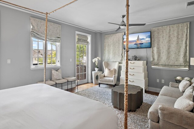 bedroom featuring ceiling fan, wood-type flooring, and access to outside