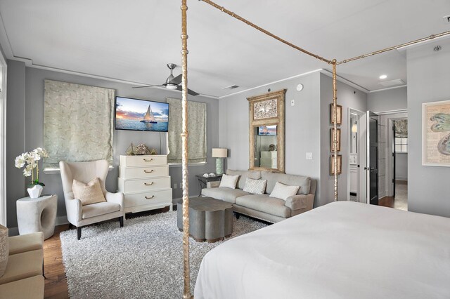 bedroom with ceiling fan, hardwood / wood-style flooring, and crown molding