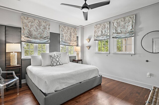 bedroom featuring multiple windows, ceiling fan, and dark hardwood / wood-style floors