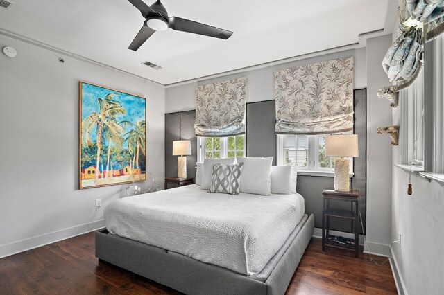 bedroom with ceiling fan and dark hardwood / wood-style floors