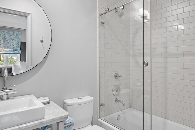 full bathroom with toilet, bath / shower combo with glass door, and vanity