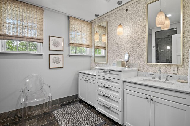 bathroom featuring vanity, a wealth of natural light, walk in shower, and tile patterned flooring