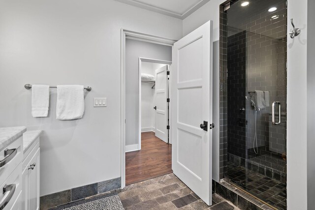 bathroom with vanity, wood-type flooring, and a shower with shower door