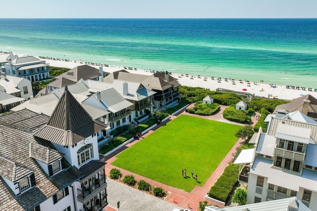 drone / aerial view featuring a water view and a beach view