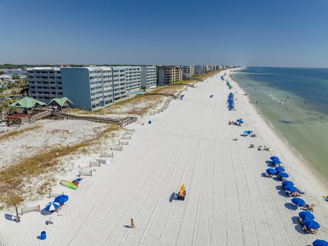 drone / aerial view featuring a water view and a beach view