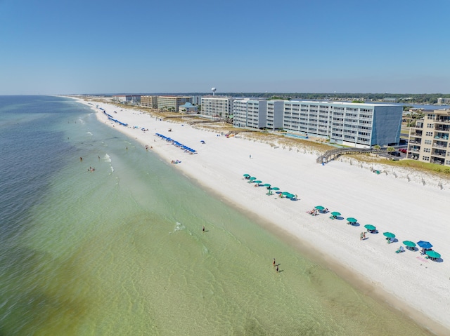 drone / aerial view with a water view and a beach view