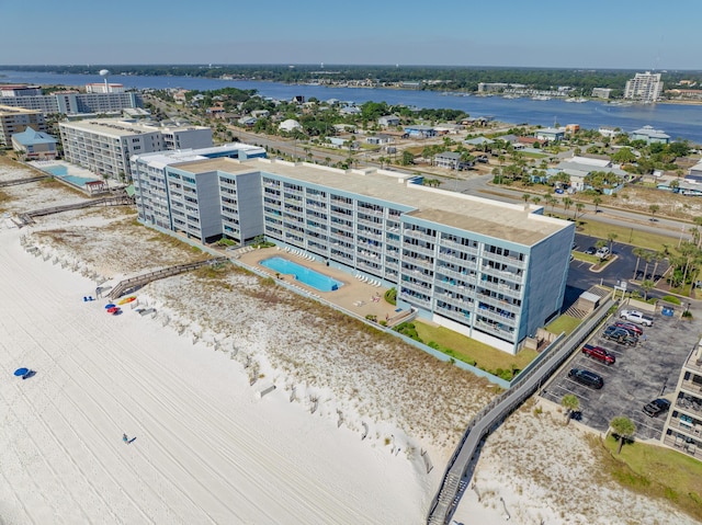 drone / aerial view of a large body of water and a pool area