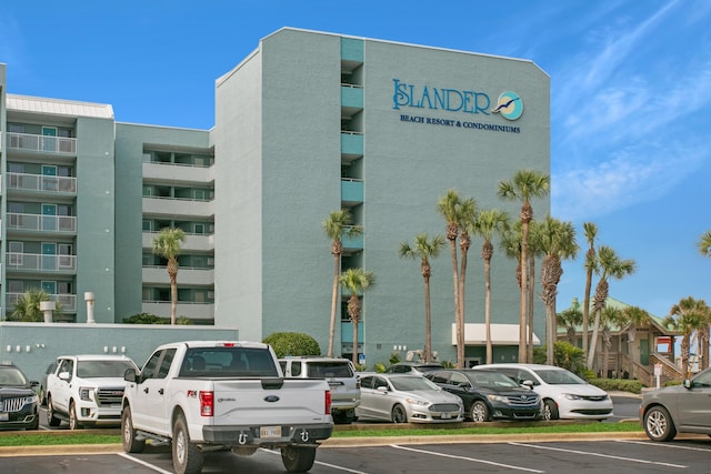 view of building exterior featuring uncovered parking