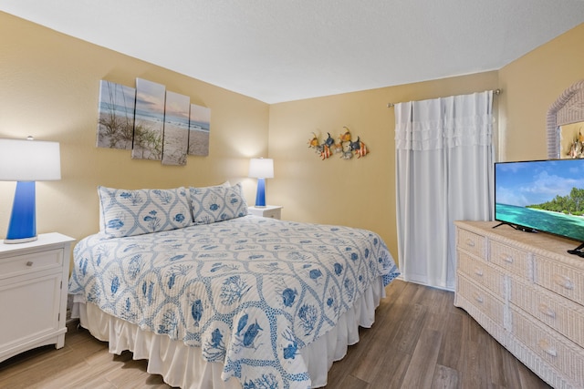 bedroom with hardwood / wood-style floors