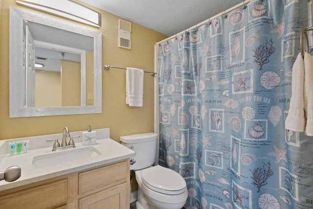 bathroom with toilet, vanity, a textured ceiling, and a shower with curtain