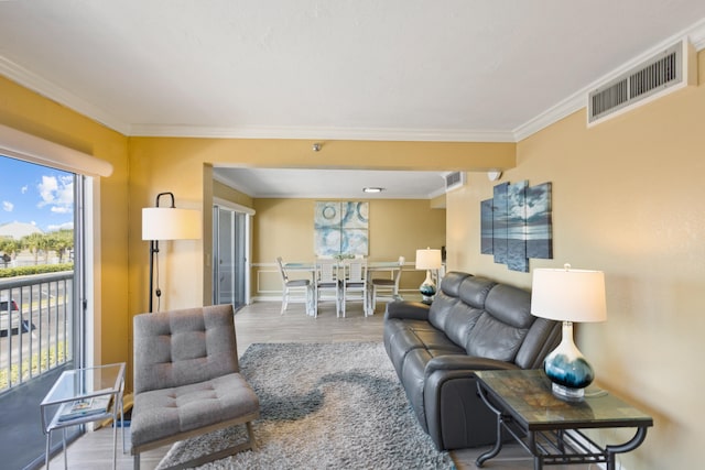 living room featuring ornamental molding and light wood-type flooring