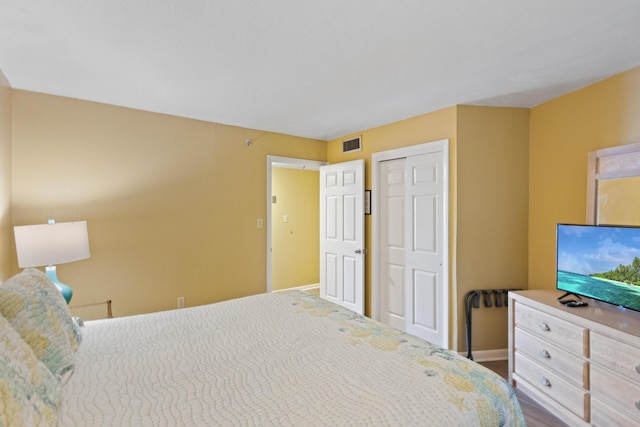 bedroom with baseboards and a closet