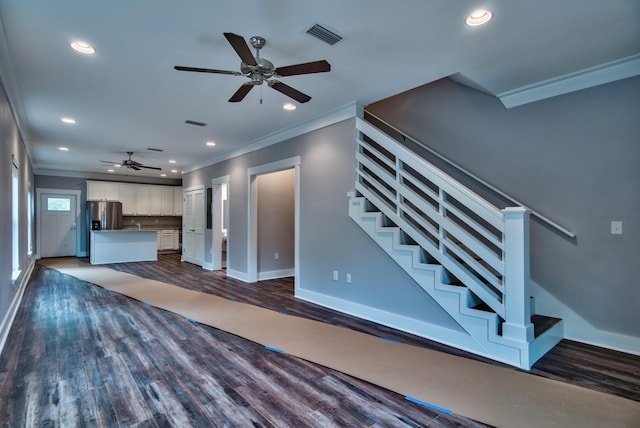 unfurnished living room featuring ceiling fan, crown molding, and dark hardwood / wood-style flooring