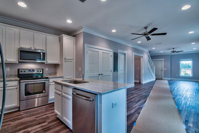 kitchen with appliances with stainless steel finishes, white cabinetry, sink, dark hardwood / wood-style flooring, and ceiling fan