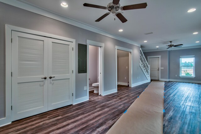 unfurnished living room with ceiling fan, ornamental molding, dark hardwood / wood-style flooring, and electric panel