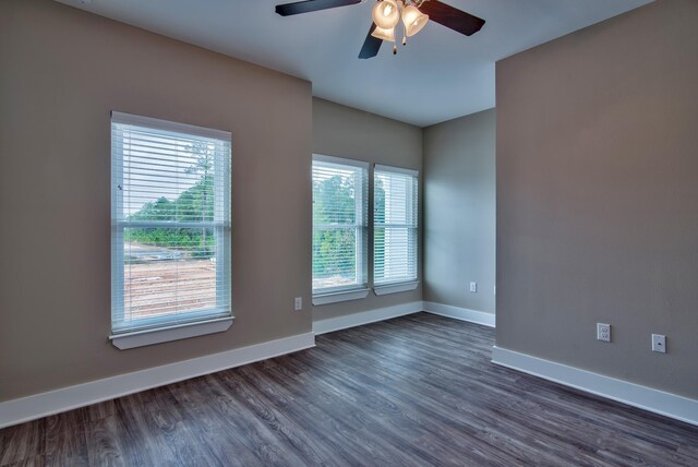 empty room with ceiling fan and hardwood / wood-style flooring