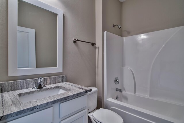 full bathroom featuring shower / bathing tub combination, toilet, and vanity