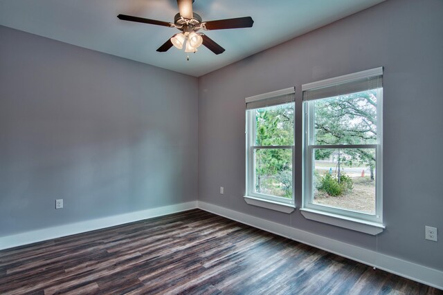 empty room featuring ceiling fan and dark wood-type flooring