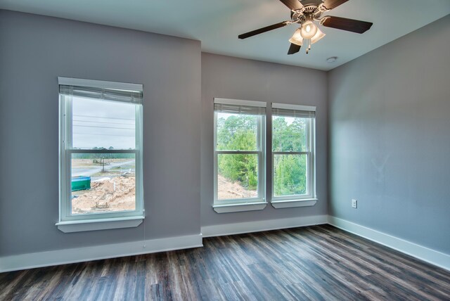 unfurnished room with ceiling fan and dark wood-type flooring