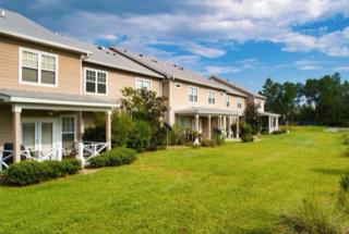 rear view of property featuring a lawn